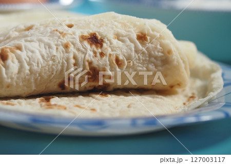 Freshly cooked tortillas on a plate ready to be enjoyed 127003117
