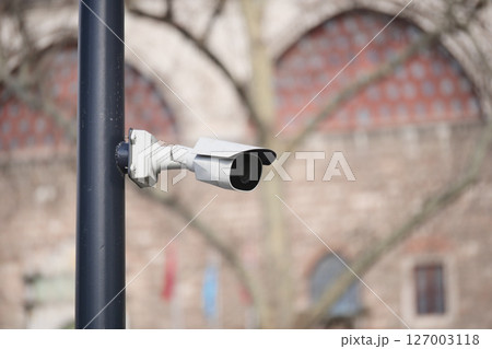 Security camera installed in urban area with historical background 127003118