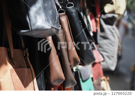 Leather bags displayed at a street market in daylight Leather bags displayed at a street market in daylight 127003220