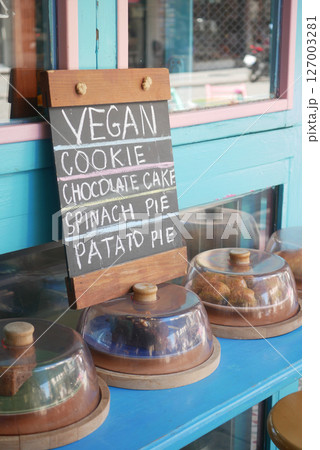 Delicious vegan treats displayed at a colorful cafe 127003281