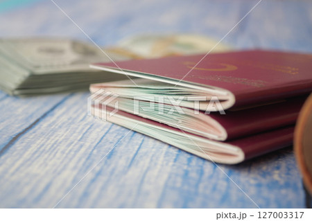 Travel preparations with passports and cash on a table Travel preparations with passports and cash on a table 127003317