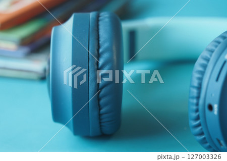Close-up of blue headphones on a colorful background Close-up of blue headphones on a colorful background 127003326