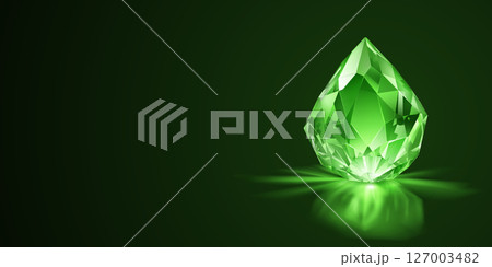 Shiny green gemstone on a dark background. 127003482