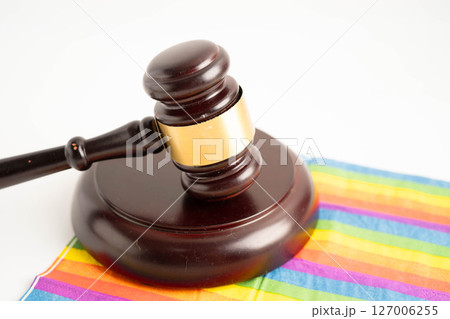 Gavel for judge lawyer on rainbow flag, symbol of LGBT pride month. 127006255