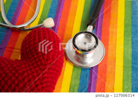 LGBT symbol, Stethoscope with red heart on rainbow flag, rights and gender equality, LGBT Pride Month in June. 127006314