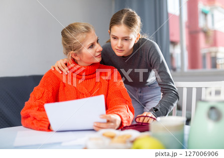 Daughter helps mom compose letter text Daughter helps mom compose letter text 127006906