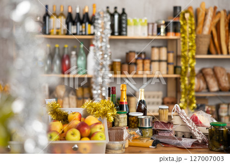 Different products on counter of grocery store 127007003