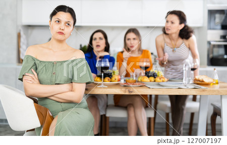 Female friends during family quarrel accuse Asian woman 127007197