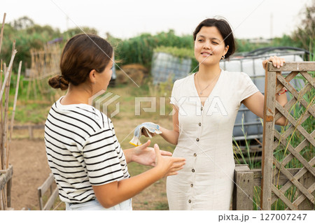 Portrait of talking colleagues in farm. 127007247