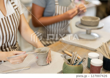 Female hands sculpting clay product close-up Female hands sculpting clay product close-up 127007426