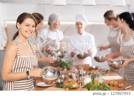 Young woman learns to cook at master class 127007455