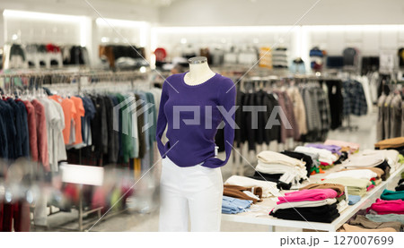 Shop mannequin wearing dark blue blouse and white pants in clothing store Shop mannequin wearing dark blue blouse and white pants in clothing store 127007699