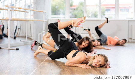 Group of women in high heels dances on floor 127007997