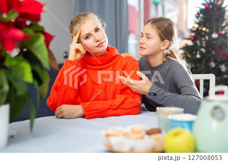 Daughter consoles mother 127008053