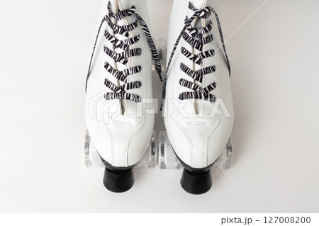 White figure roller skates with striped laces on white background 127008200