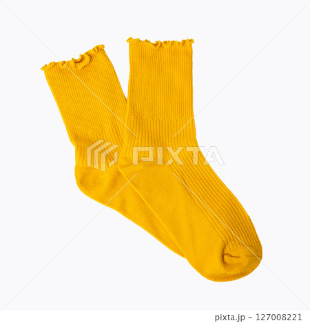 Bright yellow ruffled edge socks on white background 127008221