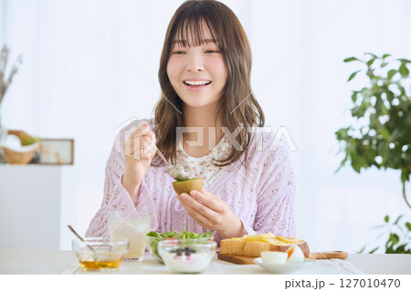 爽やかな初夏の朝に朝食を食べる女性 爽やかな初夏の朝に朝食を食べる女性 127010470