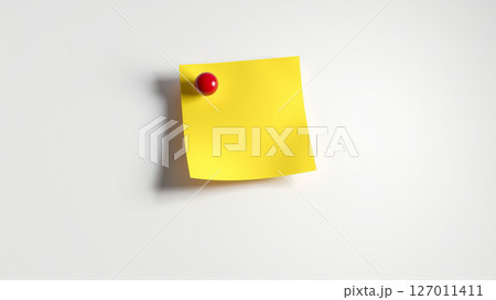 A yellow sheet of paper for notes is attached with a red pushpin to a white wall 127011411