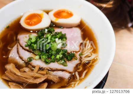 close up of Japanese ramen noodles with boiled Ajitsuke Tamago, spring onion and soft tender slice pork with noodles in soy sauce with copy space close up of Japanese ramen noodles with boiled Ajitsuke Tamago, spring onion and soft tender slice pork with noodles in soy sauce with copy space 127013706