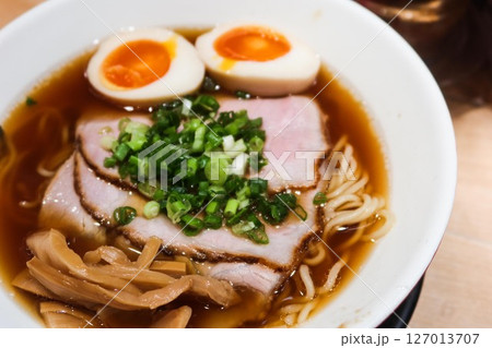 close up of Japanese ramen noodles with boiled Ajitsuke Tamago, spring onion and soft tender slice pork with noodles in soy sauce with copy space close up of Japanese ramen noodles with boiled Ajitsuke Tamago, spring onion and soft tender slice pork with noodles in soy sauce with copy space 127013707