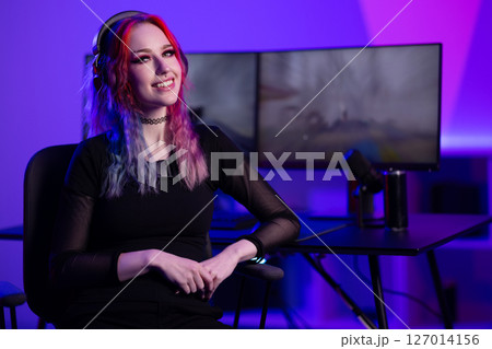 Young gamer streaming in colorful ambiance with professional setup Young gamer streaming in colorful ambiance with professional setup 127014156
