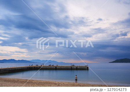 Pier in the sea at the sandy beach at cloudy sunrise n in the morning in Nha Trang in Vietnam Pier in the sea at the sandy beach at cloudy sunrise n in the morning in Nha Trang in Vietnam 127014273