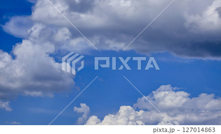 Blue sky with voluminous fluffy clouds. Thunderstorm over the river. 127014863