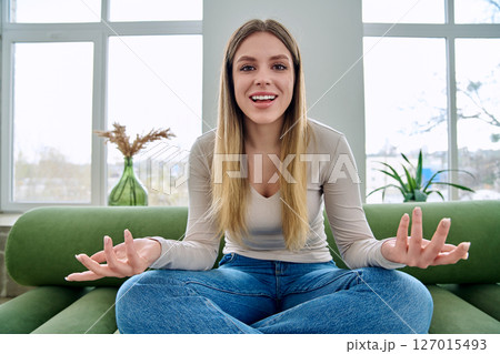 Web cam view of young woman talking looking in camera, online meeting, video call 127015493