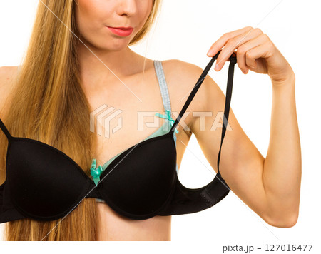 Woman trying on black pushup bra Woman trying on black pushup bra 127016477