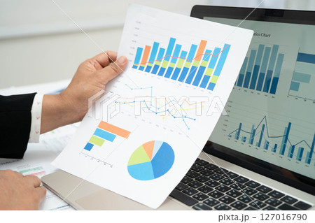 Asian business woman working with financial graph. Asian business woman working with financial graph. 127016790