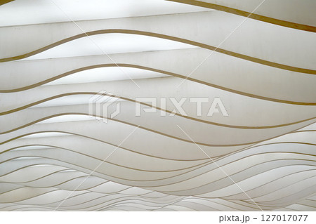 Wavy, layered panels create a dynamic, abstract pattern, playing with light and shadow. 127017077