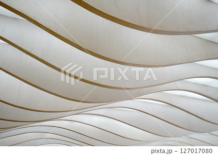 Wavy, layered panels create a dynamic, abstract pattern, playing with light and shadow. 127017080