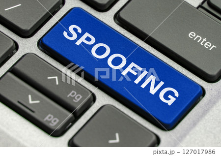 Spoofing text on keyboard showcasing threats of impersonation in digital communications 127017986