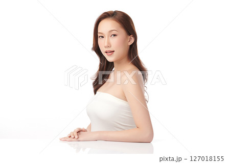 A beautiful young Asian woman with clean, fresh skin against a white background. Skincare, facial treatment, cosmetology, beauty, and spa. An elegant portrait of an Asian woman. 127018155