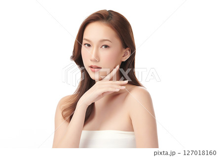 A beautiful young Asian woman with clean, fresh skin against a white background. Skincare, facial treatment, cosmetology, beauty, and spa. An elegant portrait of an Asian woman. 127018160