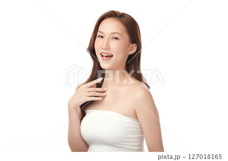 A beautiful young Asian woman with clean, fresh skin against a white background. Skincare, facial treatment, cosmetology, beauty, and spa. An elegant portrait of an Asian woman. 127018165