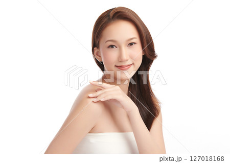 A beautiful young Asian woman with clean, fresh skin against a white background. Skincare, facial treatment, cosmetology, beauty, and spa. An elegant portrait of an Asian woman. 127018168