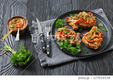 pork chops topped with bell pepper cream gravy pork chops topped with bell pepper cream gravy 127019336