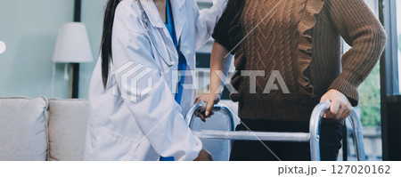 Young doctor examines senior patient's leg Young doctor examines senior patient's leg 127020162
