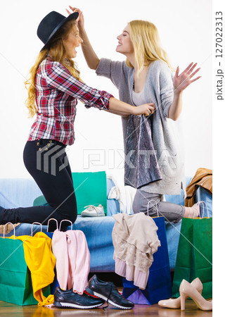 Two happy female friends after shopping 127022313