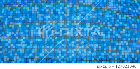 Swimming pool water surface and ripple wave with blue mosaic tiles Swimming pool water surface and ripple wave with blue mosaic tiles 127023046