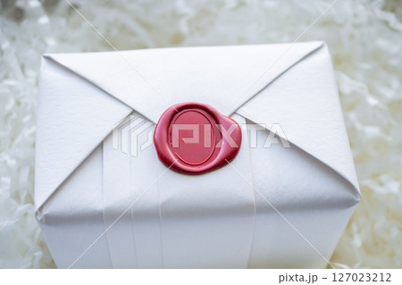 Wax seal stamp on white paper wrap packaging parcel box 127023212