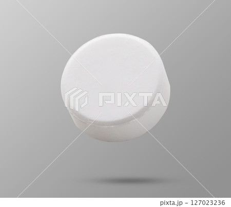 White medicine pill tablet flying on background White medicine pill tablet flying on background 127023236