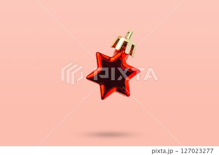 Red Christmas star ornament bauble isolated on pink background 127023277