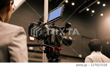 Professional cinema cameras being used in a studio or event setting. High end gear with crew operation and behind the scenes video production in action. Camera for Live recording and broadcasting. Professional cinema cameras being used in a studio or event setting. High end gear with crew operation and behind the scenes video production in action. Camera for Live recording and broadcasting. 127023326
