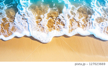 waves on the beach, view of a sandy beach with a gentle ocean wave washing ashore. The soft foam contrasts with the fine sand, peaceful coastal scene, smooth sand in the foreground, gentle ocean wave 127023669