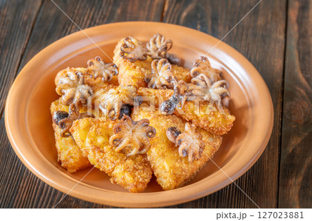 Golden Potato Rosti With Baby Octopuses Served On Rustic Wooden Table Plate Golden Potato Rosti With Baby Octopuses Served On Rustic Wooden Table Plate 127023881