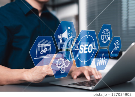 SEO Search Engine Optimization Strategy Concept. Businessman using laptop with SEO-related icons such as link building, analytics, global web targeting to boost online visibility, digital marketing, 127024902