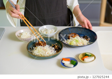 料理を箸で取り分ける手元が伝える丁寧な暮らし 127025244