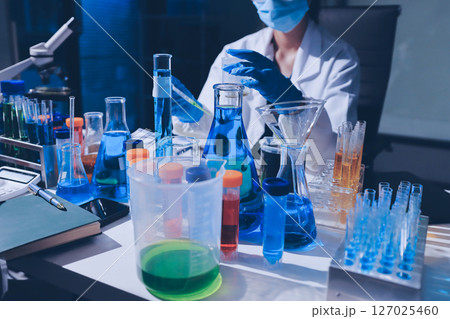 Scientist pipetting medical samples into microplate in laboratory Scientist pipetting medical samples into microplate in laboratory 127025460